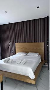 a bedroom with a large bed with white sheets at Vila Klea in Ksamil