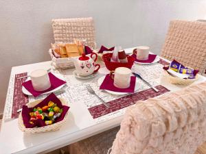 a table with a tea set on top of it at Le Chalet Palermo Centro in Palermo