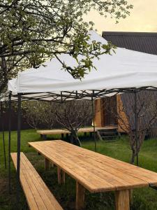a wooden picnic table with a white umbrella at Delta Rest House in Nor Hachyn