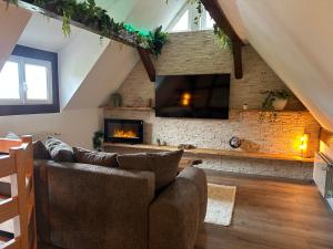 a living room with a couch and a fireplace at La Cabane in Dambach-la-Ville