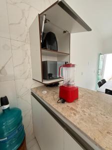 a kitchen with a blender on a counter at Casa Perfeita Paracuru in Paracuru +14 photos
