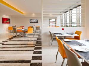 a dining room with a table and chairs at ibis Nashik - An Accor Brand in Nashik
