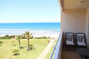 a balcony with chairs and a view of the beach at Santa Ana 22 by homeprive in El Verger