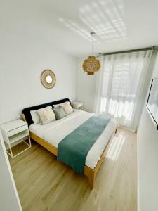 a bedroom with a large bed and a clock on the wall at Marina Real 82 by homeprive in Denia
