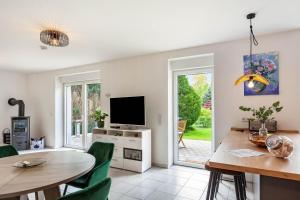 a living room with a dining table and a television at Ferienwohnung Seeglück in Lauchhammer