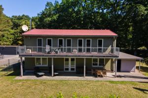 a house with a large balcony and a deck at Ferienhaus Träumerei am Plauer See in Alt Schwerin