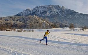 a man is cross country skiing in the snow at Komfortzimmer Widauer in Ebbs