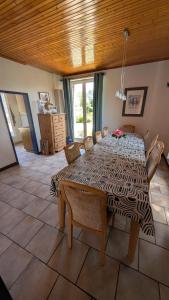 a dining room with a table and some chairs at Manoir du Taillis in Heugon