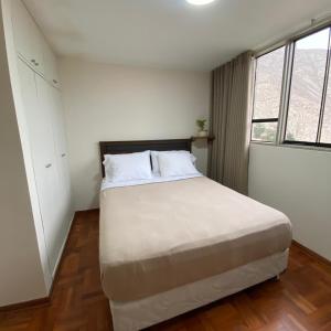 a bedroom with a large white bed with two pillows at La casa del cuadro in Lima +16 photos