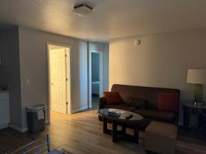 a living room with a couch and a table at The Lake Huron Resort in Oscoda