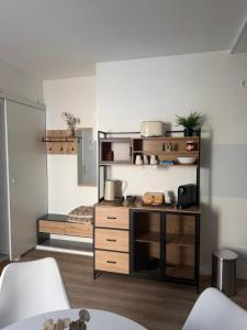 a room with a kitchen with a table and a shelf at Dianas Ferienwohnung 1 in Feldberg +12 photos