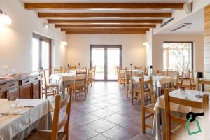a restaurant with tables and chairs in a room at Hotiday Cala Gonone in Cala Gonone