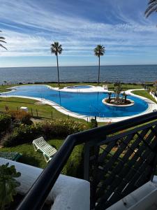 a view of a swimming pool next to the ocean at Mi Capricho in Mijas Costa