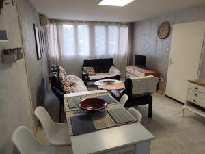 a living room with a couch and a table at Jela - Spacious Two-Bedroom Apartment near City Center with Free Parking & Wi-Fi in Podgorica