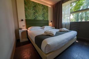 a bedroom with a large bed with a large window at Best Western Hotel Green City in Parma +123 photos