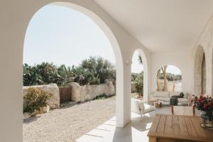 an archway in a living room with a couch and a table at SON MARTORELL by BookMenorcaVillas Unique country house in Mahón