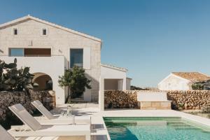 a villa with a swimming pool and a house at SON MARTORELL by BookMenorcaVillas Unique country house in Mahón