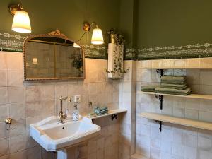 a bathroom with a sink and a mirror at Villa Belle in Freudenberg +17 photos