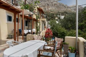 a balcony with a table and chairs on a house at Yiorgo's Studios in Kalymnos