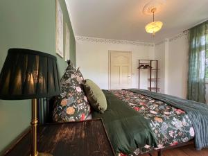 a bedroom with a bed with a lamp and pillows at Villa Belle in Freudenberg