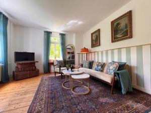a living room with a couch and a table at Villa Belle in Freudenberg