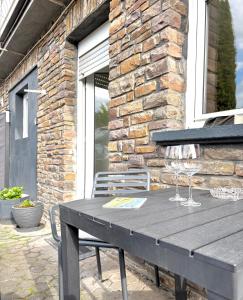 ein Holztisch mit Weingläsern auf einer Terrasse in der Unterkunft Hill-Suite in Cochem