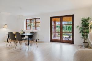 a dining room with a table and chairs at Cozy house with garden in Odense