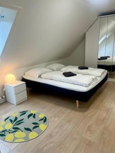 a bedroom with a bed and a rug on the floor at Cozy house with garden in Odense