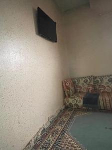 a living room with a couch and a flat screen tv at MRIRT Home N4 in Jemaa de Mrirt +5 photos