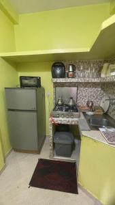 a small kitchen with a stove and a sink at MRIRT Home N4 in Jemaa de Mrirt