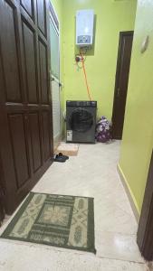 a room with a door and a television and a rug at MRIRT Home N4 in Jemaa de Mrirt