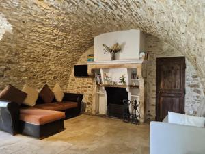 a living room with a couch and a fireplace at Gite 5 personnes SOLOGNE in Hargeville +10 photos