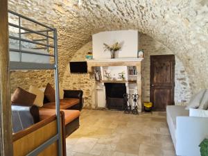 a living room with a bunk bed and a fireplace at Gite 5 personnes SOLOGNE in Hargeville