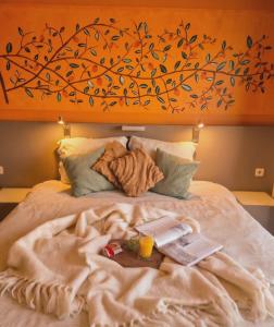 a bed with a plate of food on it at B&B The Protea in Zonnebeke +8 photos