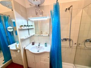a bathroom with a sink and a shower at Excelsior Relaxing Apartment in Levanto +6 photos