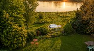 an aerial view of a garden with a boat on the water at Holistyczne Ujęcie in Głody