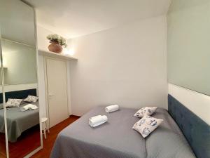 a small room with a bed and a mirror at Excelsior Relaxing Apartment in Levanto