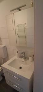 a bathroom with a white sink and a toilet at A&H Apartment in Oberhausen +43 photos