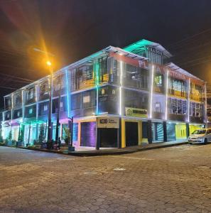 a building at night with a car parked in front at Hotel Cristian in Puyo
