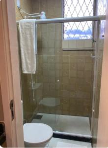 a bathroom with a shower with a toilet and a sink at Loft Campinho 2 in Estação Inhoaíba