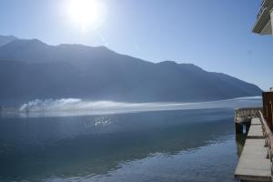 a view of a lake with mountains in the background at Feet in the water! in Duingt