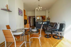 a dining room with a glass table and chairs at Feet in the water! in Duingt +4 photos