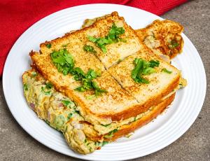 a white plate with two grilled cheese sandwiches on it at Snowpeak Retreat in Hundar