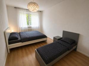 a bedroom with two beds and a window at Pulheim Living 5 in Pulheim