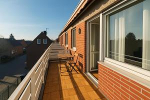 a balcony with a bench on the side of a house at Pulheim Living 5 in Pulheim
