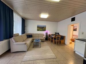 a living room with a couch and a table at Ferienwohnung Stani in Leibnitz
