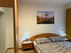 a bedroom with a bed and a picture of a windmill at Ferienwohnung Stani in Leibnitz