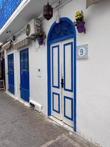 a blue door on the side of a white building at Tangier city center 3 in Tangier