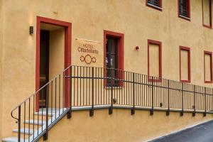 a building with a balcony with a sign on it at Hotel Cittadellarte in Biella