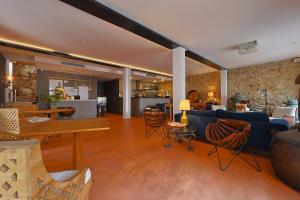 a living room with a blue couch and a table at Casa de São Bento by PURUS in Coimbra